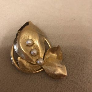 Gold metal and pearl brooch